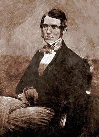 A daguerreotype of a man seated with his hand folded in his lap.